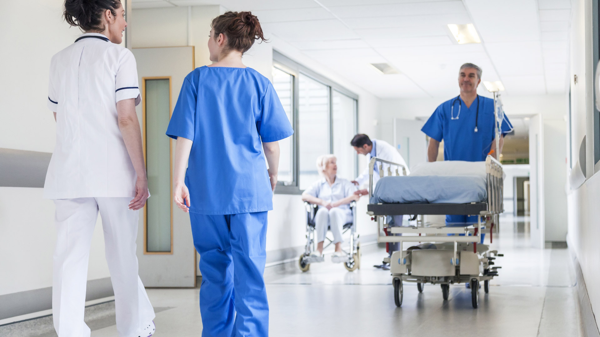 Medical person pushing trolley in a hospital setting